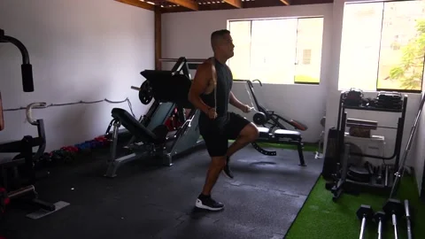 Slow motion of a man jumping rope and doing more complex jumps and failing Stock Footage 146506719