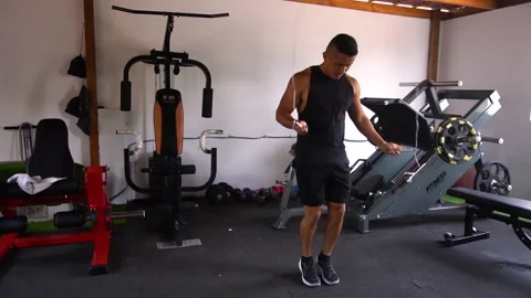 Slow motion of a man jumping rope and doing more complex jumps Stock Footage 146506838