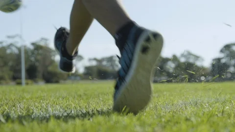 Slow motion man kicks soccer ball on soccer field slowmo 200fps Stock Footage 87545855
