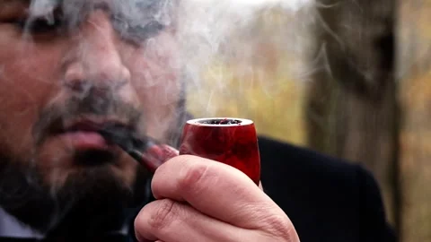 Slow Motion of Man Lighting Pipe and Puffing Smoke (Full HD) Stock Footage 296705890