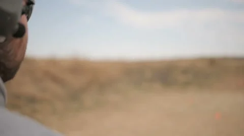 Slow Motion Man Loads and Fires a Handgun Stock Footage 60691437