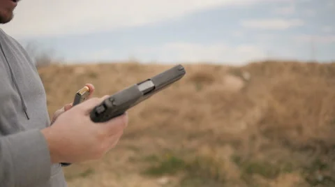 Slow Motion Man Loads Magazine Into Handgun Stock Footage 60690768