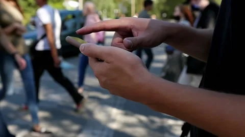 Slow motion man looking at mobile phone walking down the street to office Stock Footage 143401858