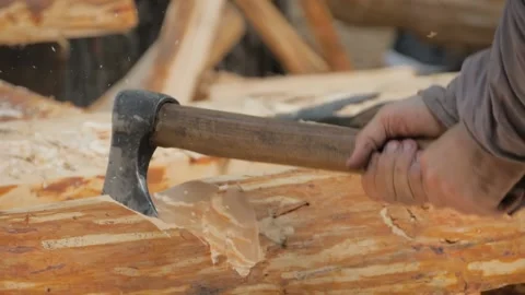 Slow motion: man lumberjack cutting large log with axe at historical festival Stock Footage 141853272