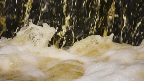 Slow motion: man-made waterfall, water discharge through a dam. Foam forms on 스톡 동영상 169995929