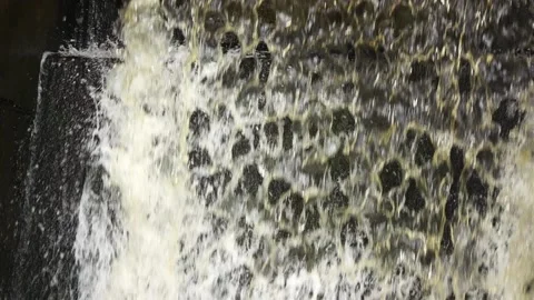 Slow motion: man-made waterfall, water discharge through a dam. Stock Footage 170591031