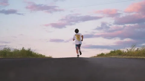 Slow motion of a man man running at sunset Stock Footage 241717968