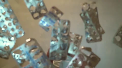 Slow motion man in the mask throws the on the table empty blister packs Stock Footage 130198197