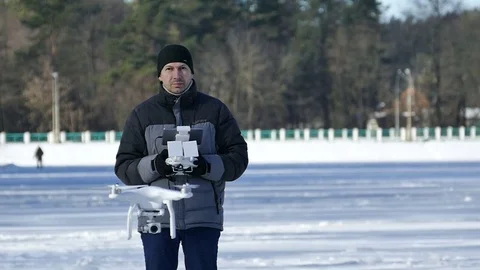 Slow motion. Man operates  flying  drone with camera for  Radio transmitter  Stock Footage 72153171