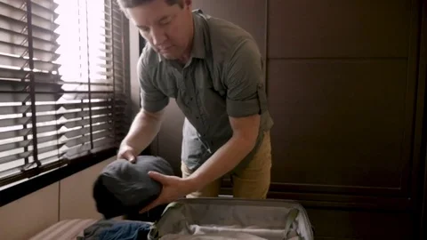 Slow motion of a man packing his clothes in a suitcase for a trip 스톡 동영상 84084864