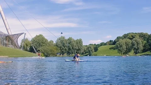 Slow motion of man on paddle in lake in Olympia park, summer water sports 스톡 동영상 106598374