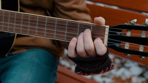 Slow Motion man in the Park plays guitar in winter Видео 98009743