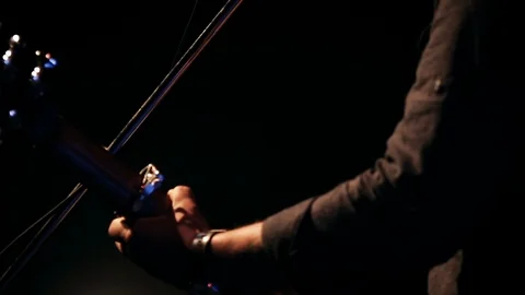 Slow motion, man passes in front of guitar player performing on stage Vídeos de archivo 99068718