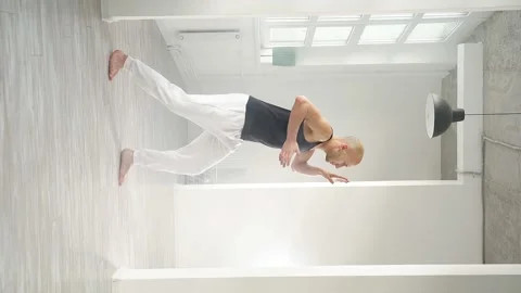 Slow motion of a man performing elements of modern dance in a bright studio Stock Footage 169224490