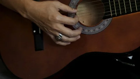 Slow motion of man playing guitar close up. Stock Footage 104070155
