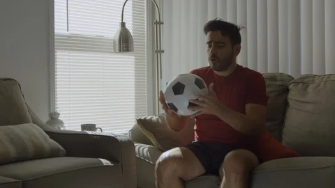 Slow motion of a man playing with soccer ball at home Stock Footage 114644695