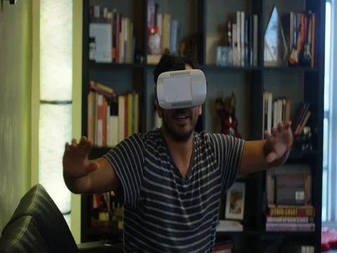 Slow motion of man playing with a VR headset at home Stock Footage 78490939