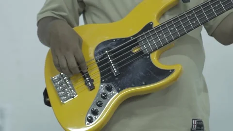 Slow Motion Of Man Playing A Yellow Bass Guitar Stock Footage 300724441