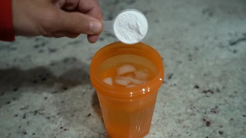 Slow motion: Man pouring pre-workout powder into mixer before his workout Stock Footage 119467980