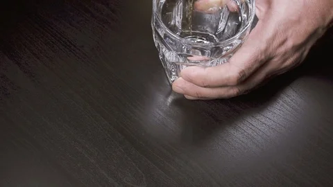 Slow motion the man pours whiskey into a glass top view Stock Footage 87468878