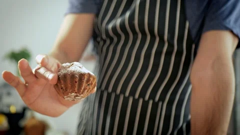 Slow motion. A man puts a gorgeous cupcake on a plate of perfect cupcakes Stock Footage 258753782