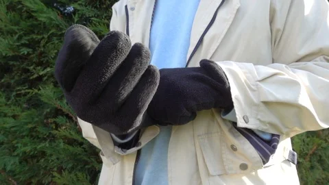 Slow motion: Man putting on winter gloves. Stock Footage 96058625