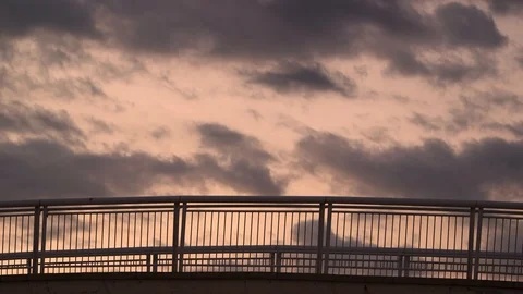 Slow Motion Of A Man Running On A Bridge At Sunset Video stock 127100088