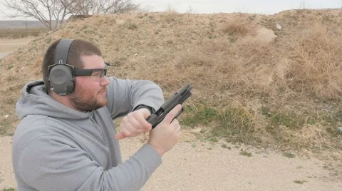 Slow Motion Man Running Out of Ammo in Semi Automatic Handgun Stock Footage 60689412