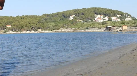 Slow Motion Man Running on the Sandy Beach to Hills Stock Footage 54916113