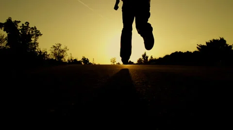 SLOW MOTION: man running at sunset Stock Footage 32230253