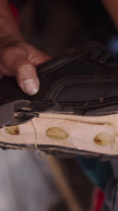Slow motion man shoemaker cuts the old antique sole of a shoe to repair it Stock Footage 279277065