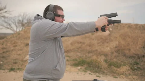 Slow Motion Man Shooting Two Semi Automatic Handguns Stock Footage 60689344