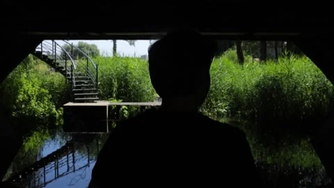 Slow Motion Of A Man In Silhouette Running Underneath A Bridge Stock Footage 130676802