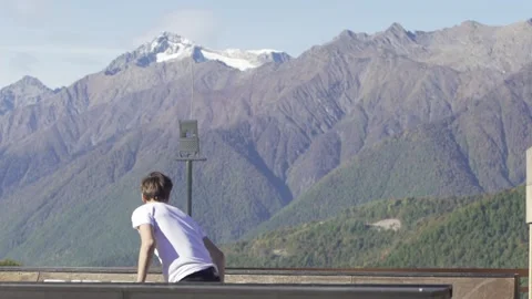 Slow motion man skateboarding doing extreme frontside air. Mountains view Stock Footage 149259567