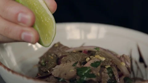 Slow motion for man squeezing fresh lime into a food juicy food hand lemon Video stock 109462600