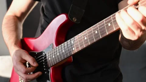 Slow Motion of Man Strumming Red Electric Guitar Close Up Stock Footage 332905708