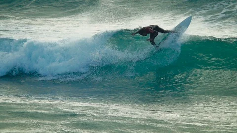 Slow-motion of a man surfing, than after a turn he fails Stock Footage 85559497