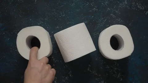 Slow motion man takes last toilet paper roll from a dark blue store shelf Stock Footage 126330441