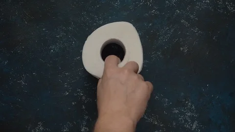 Slow motion man takes last toilet paper roll from a dark blue store shelf Stock Footage 126330464