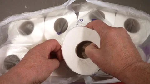 Slow motion – Man taking a new white toilet roll from a multipack. Stock Footage 114506404