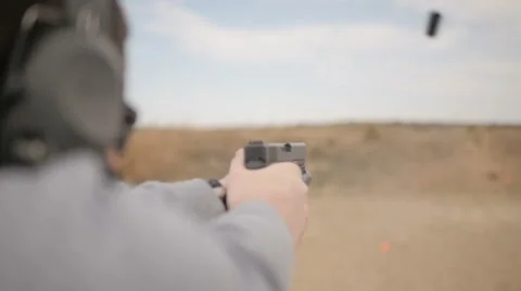 Slow Motion Man Taking Several Shots with a Handgun Stock Footage 60691471