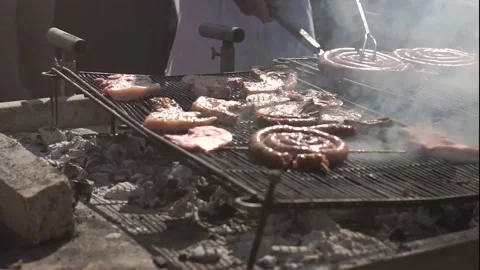 Slow Motion Of A Man Turning The Meat On The Grill Stock Footage 155791079