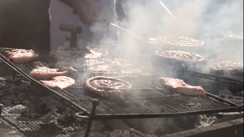 Slow Motion Of A Man Turning The Meat On The Grill. BBQ Smoke Stock Footage 155791084