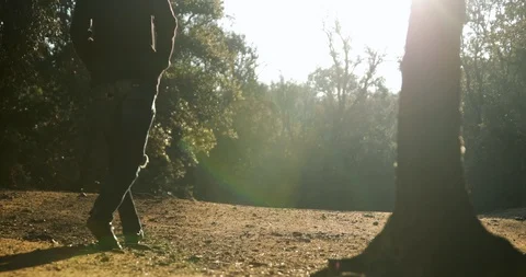 Slow Motion of Man walking in cold forest during sunrise 스톡 동영상 122764804