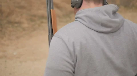 Slow Motion Man Walking with a Shotgun Stock Footage 60691171