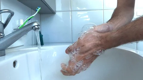 Slow motion of a man washing hands with soap in the bathroom sink Stock Footage 127100117