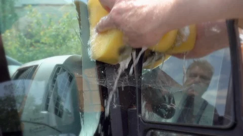 Slow motion: Man washing the wing mirror of a van. Stock Footage 89901815