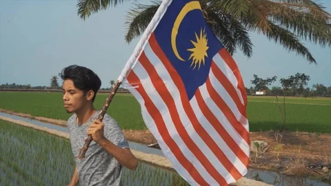 Slow motion a man waving Malaysia flag. Merdeka or Independent Day. Stock Footage 94013003
