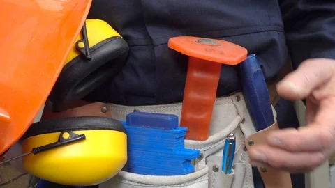 Slow motion – Man wearing tool belt holder and holding hard hat. Stock Footage 103803370