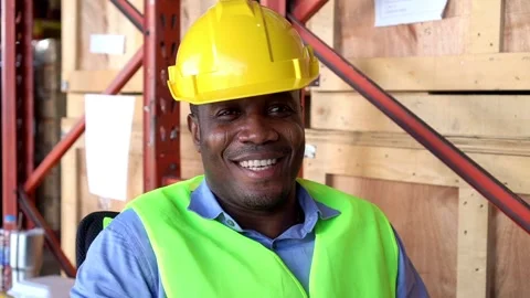 Slow motion man worker African American black sit near shelf in warehouse 動画素材 153384831